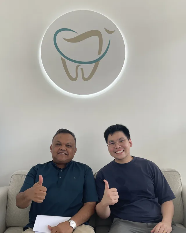 Ivory Dental team members under the clinic's tooth logo
